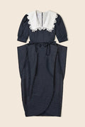 Navy polka dot dress with structure at the waist and white lace details on the collar/neckline