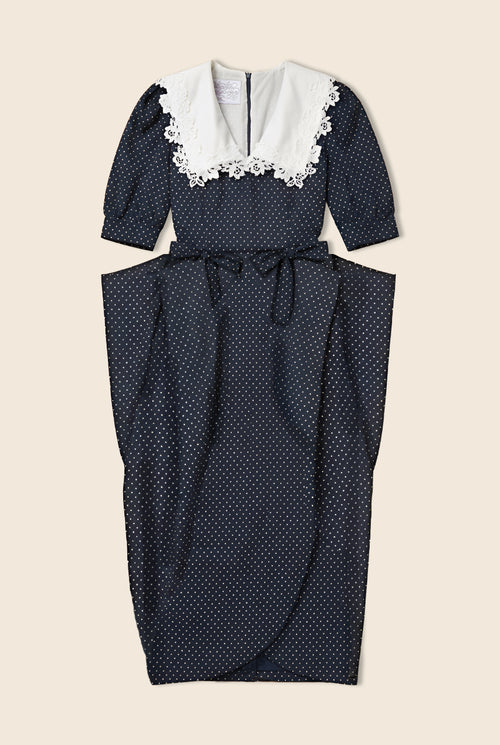Navy polka dot dress with structure at the waist and white lace details on the collar/neckline