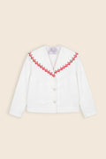 white jacket with red floral detail along the collar edge 