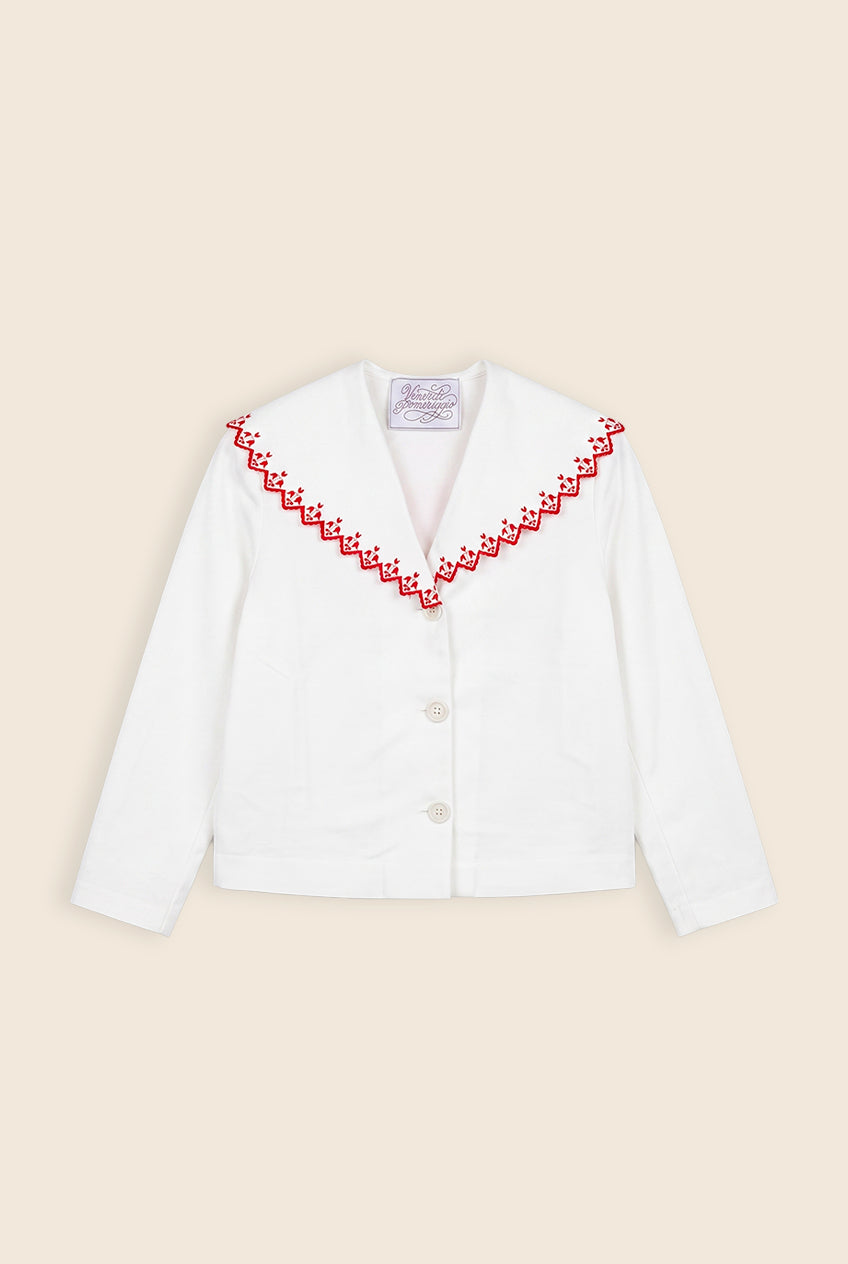 white jacket with red floral detail along the collar edge 