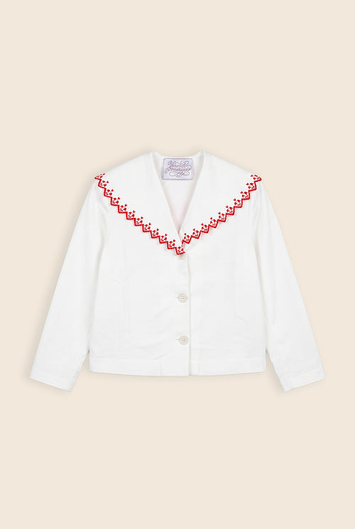 white jacket with red floral detail along the collar edge 