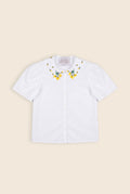 white collared shirt with floral embroidery on the collar and puffy sleeves 