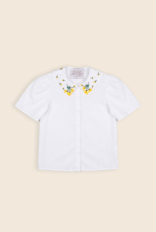 white collared shirt with floral embroidery on the collar and puffy sleeves 