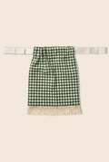 Green and white checkered pouch bag with fringe, featuring sheer polka dot lining on the inside. 
