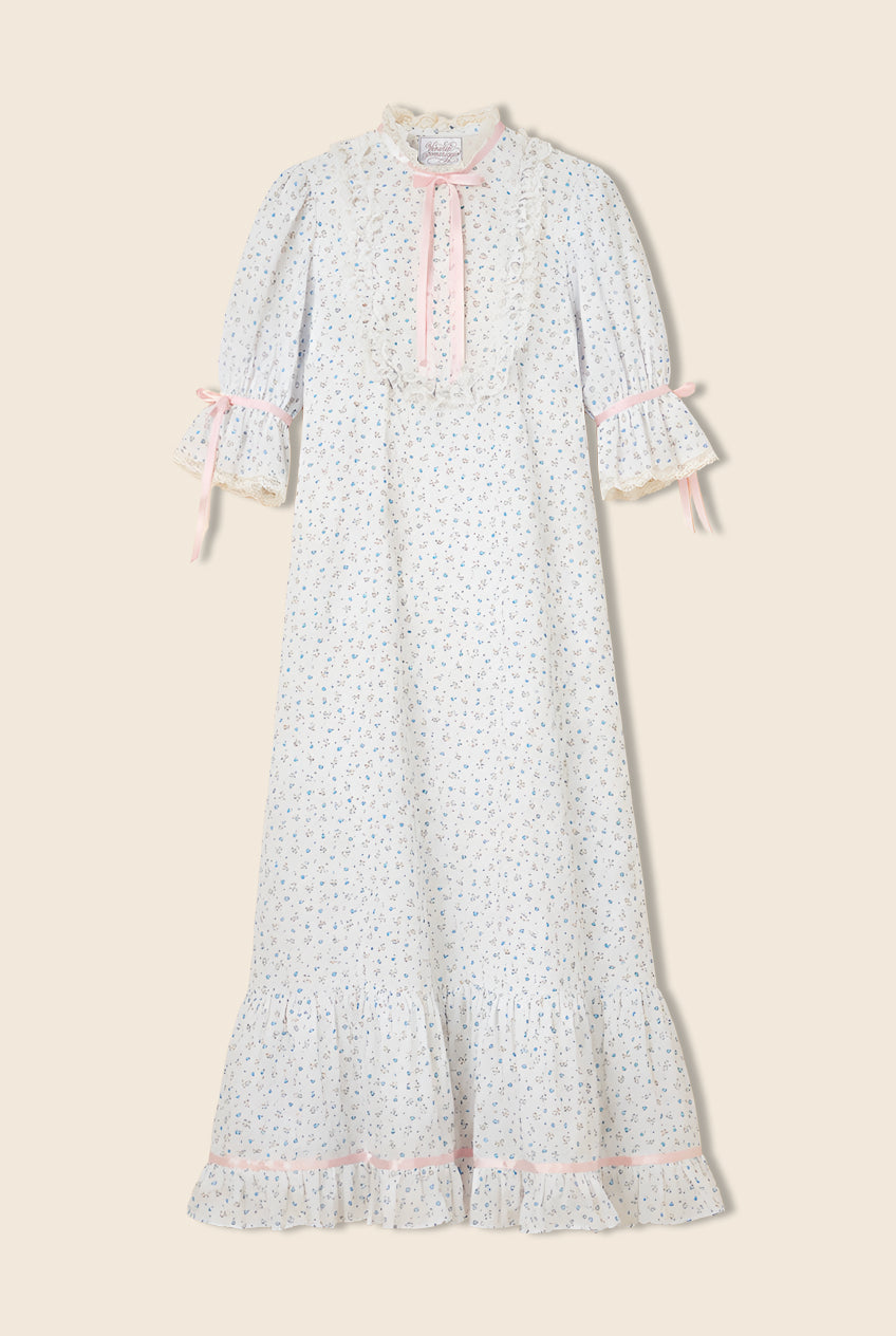 Floral dress with ruffled sleeves, collar, and chest with pink bow details throughout