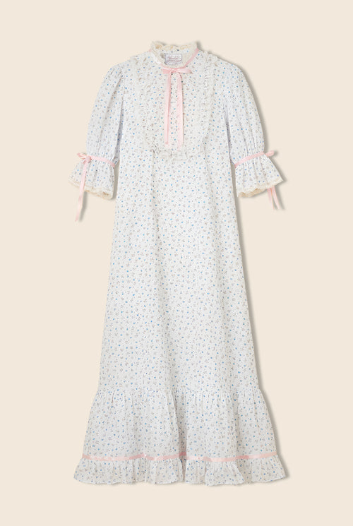 Floral dress with ruffled sleeves, collar, and chest with pink bow details throughout