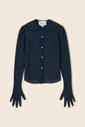 Navy blue button down shirt with white polka dots and sleeves that go down into gloves