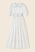 White maxi dress with floral embroidery on the waist and rounded collar 