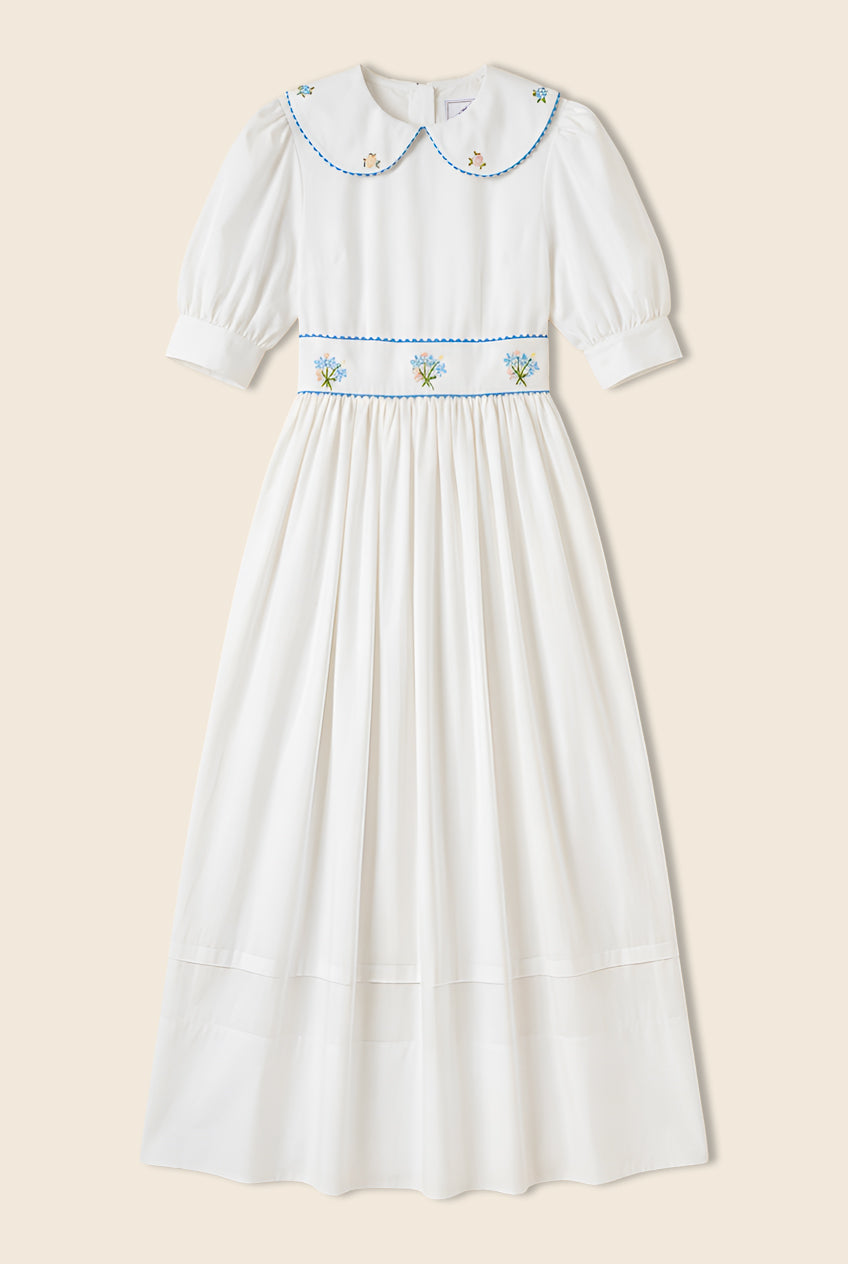 White maxi dress with floral embroidery on the waist and rounded collar 
