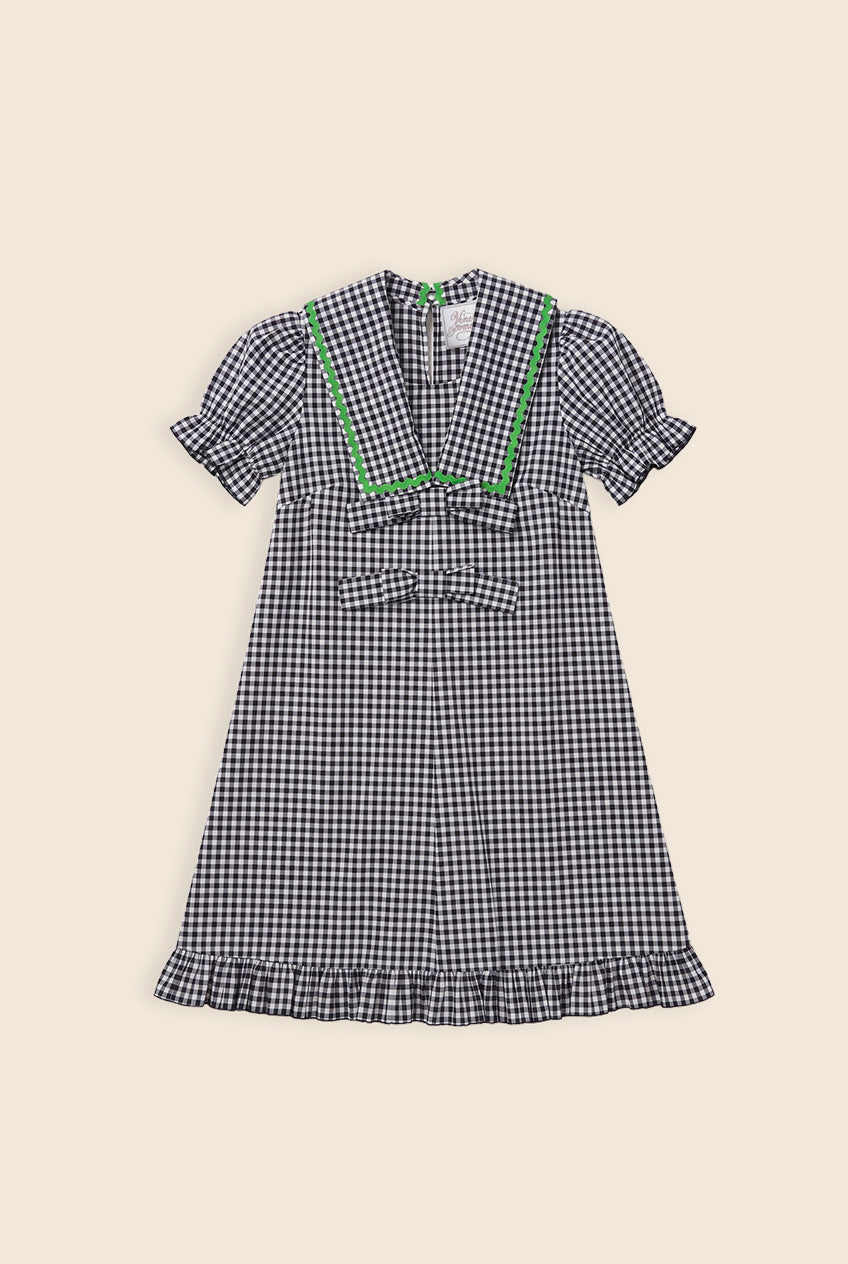 navy and white checkered mini dress with bows and green zigzag detailing on the collar 