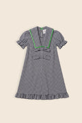 navy and white checkered mini dress with bows and green zigzag detailing on the collar 