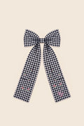 Navy blue and white checkered bow hair clip with embroidered flowers and VP logo